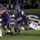 Running back Tyrell Sutton #19 of the Northwestern Wildcats follows the block of lineman Ryan Keenan #56 as linebacker Chris Graham #37 of the Michigan Wolverines dives for a tackle during a game on October 29, 2005 at Ryan Field at Northwestern University in Evanston, Illinois.